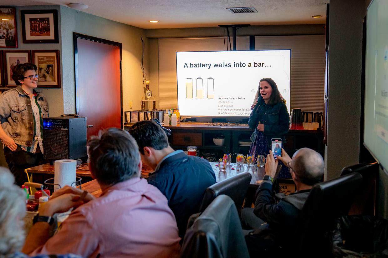 Woman giving a science talk in a bar