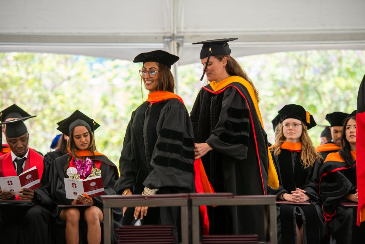 woman being hooded by advisor